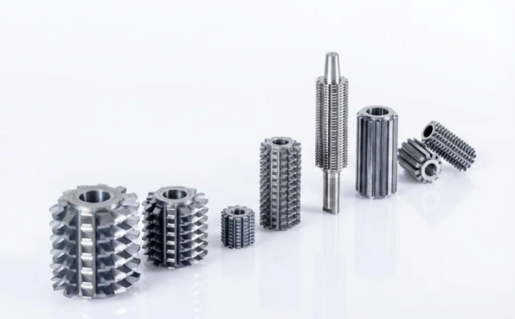 This is a product collection from Nobeve. Nobeve's entire range of gear cutting tool is arranged in a diagonal pattern, with their reflections visible on the tabletop.